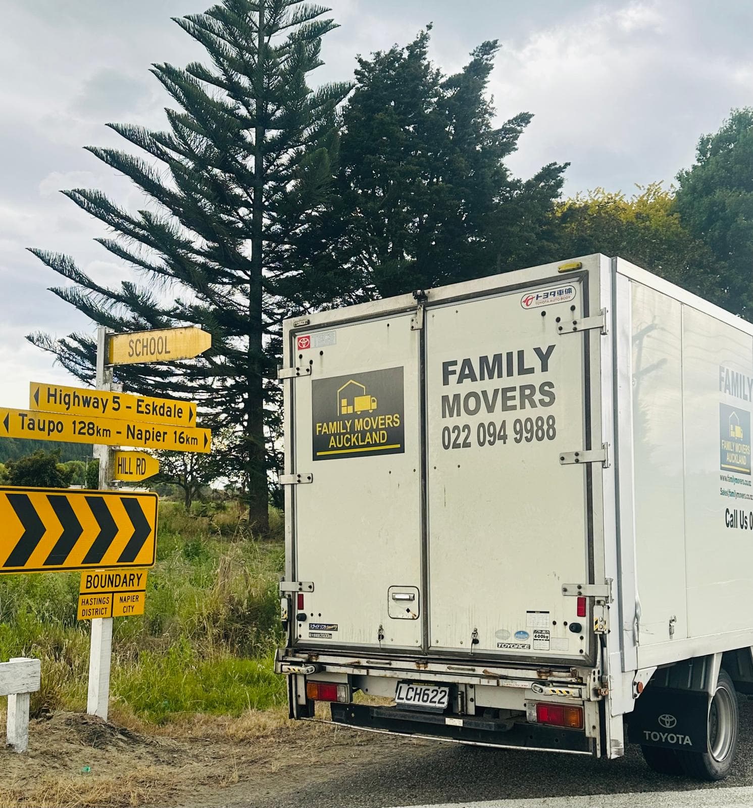 Family Movers truck with crew handling a sofa at a residential move